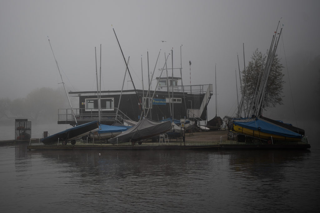 View of Hampton Sailing Club, the river Thames, on a misty autumn morning