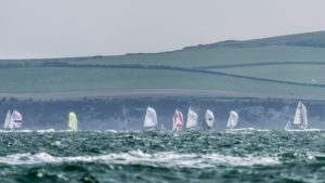 Yachts racing in Poole Regatta 2022. Poole Bay with the purbeck hills in the background