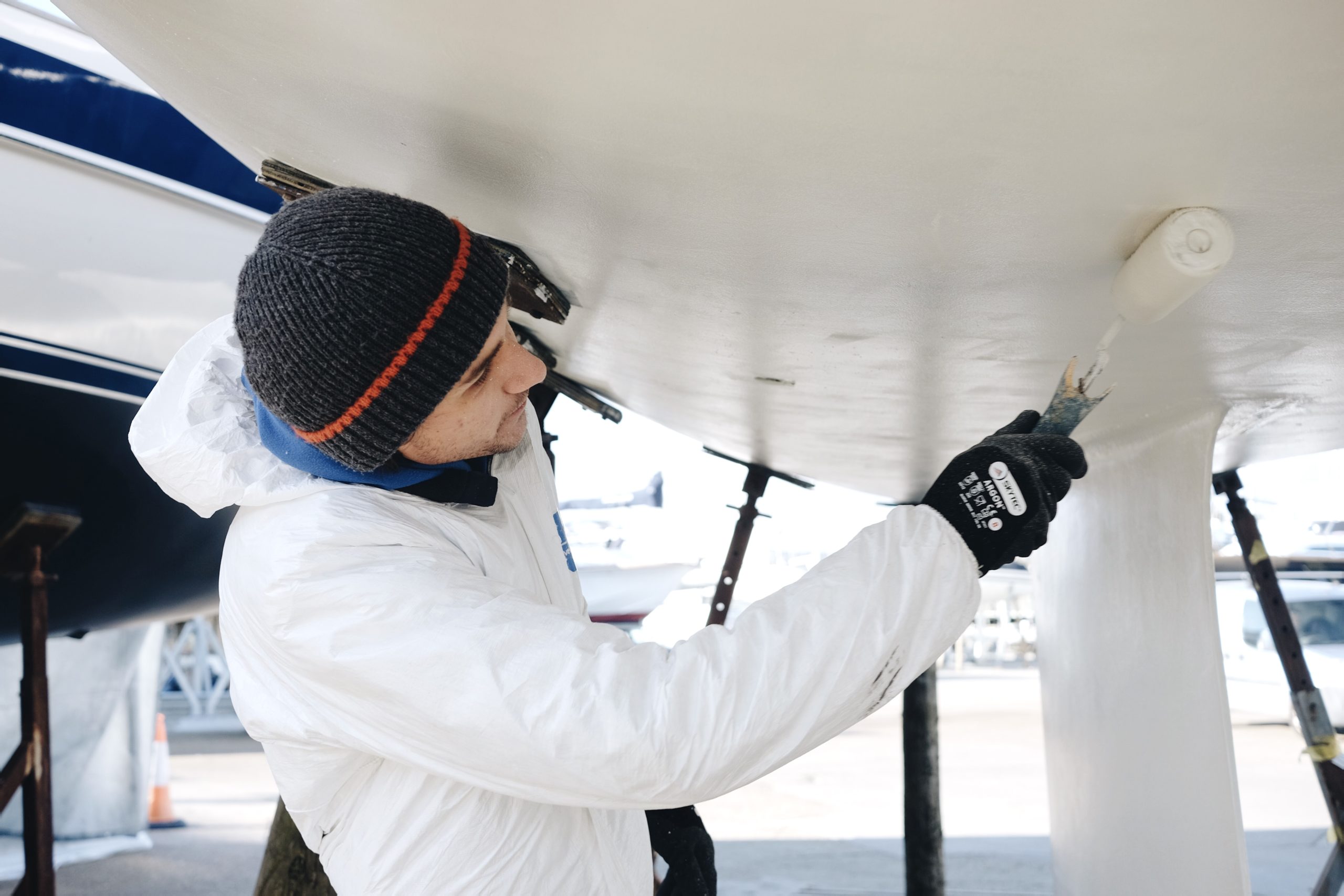 Fleet technician Sam antifouling a yacht at Hamble Point Yacht Charters. Tips to Manage Risk as a Subcontractor article.